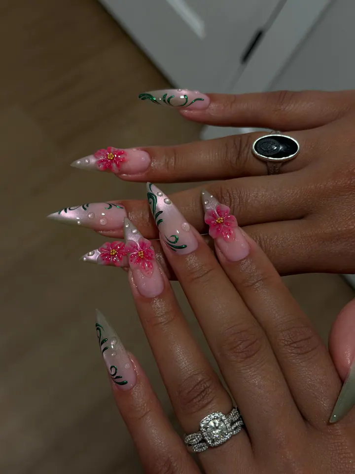 Stiletto nails with raised pink flowers, green vine linework and tiny pearls