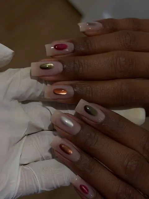 Structured manicure with round cat-eye accents in fall tones