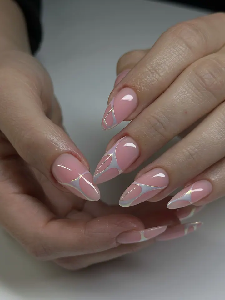 Long almond nails in pink with an iridescent silver swirl