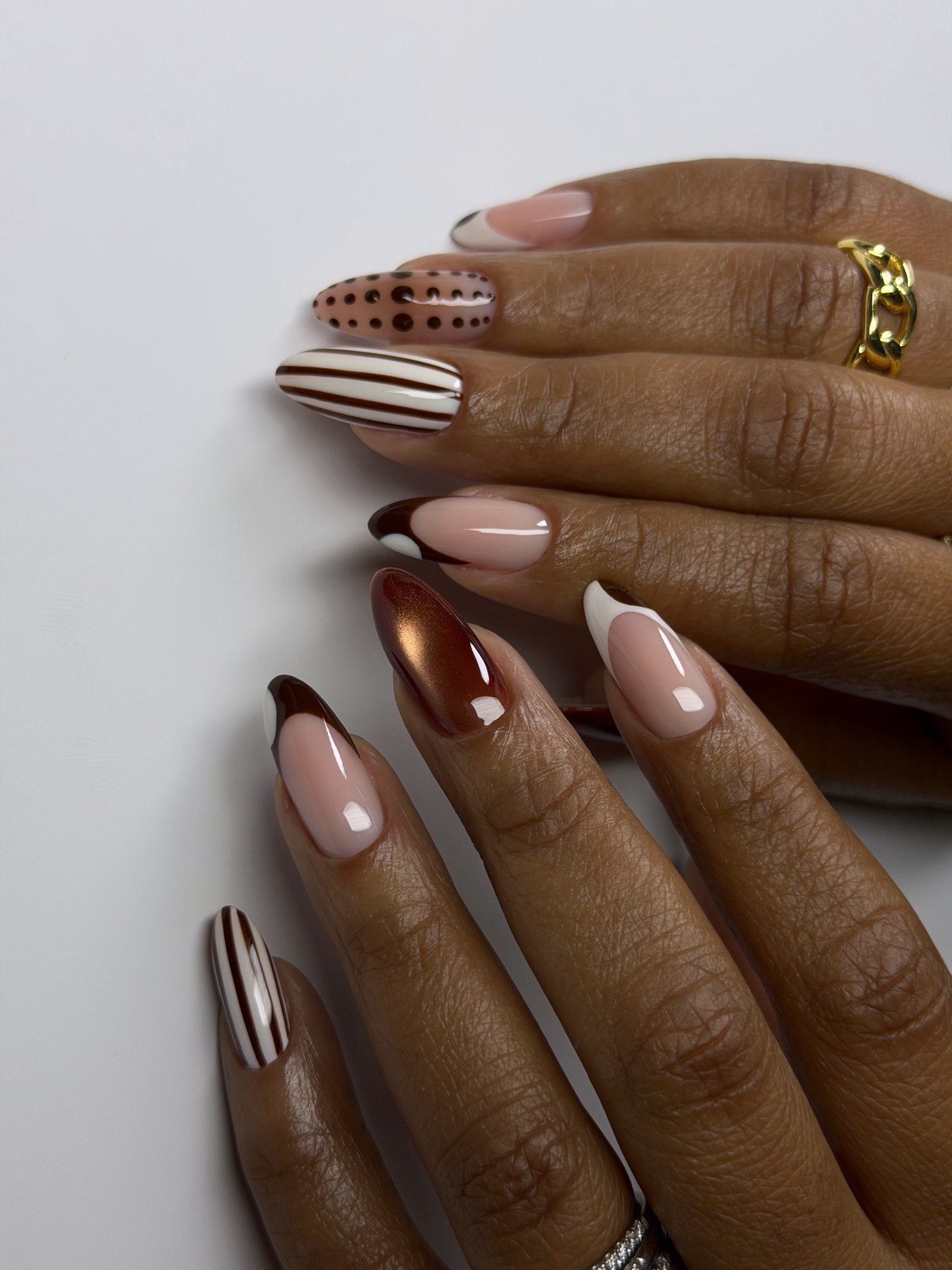 Long square French tips in milky white with tiny silver star sparkles, on a grey table