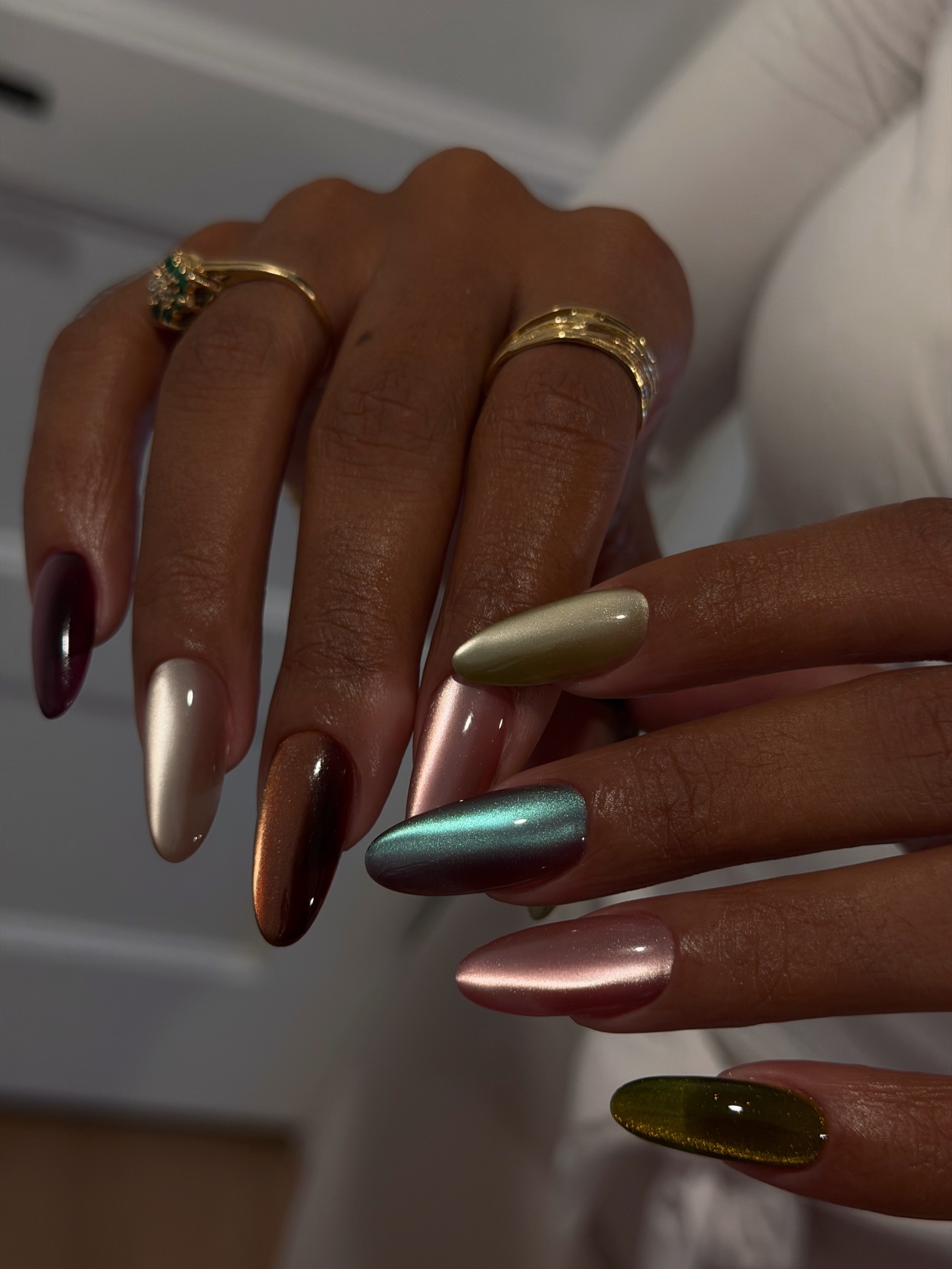 Long square French tips in milky white with tiny silver star sparkles, on a grey table