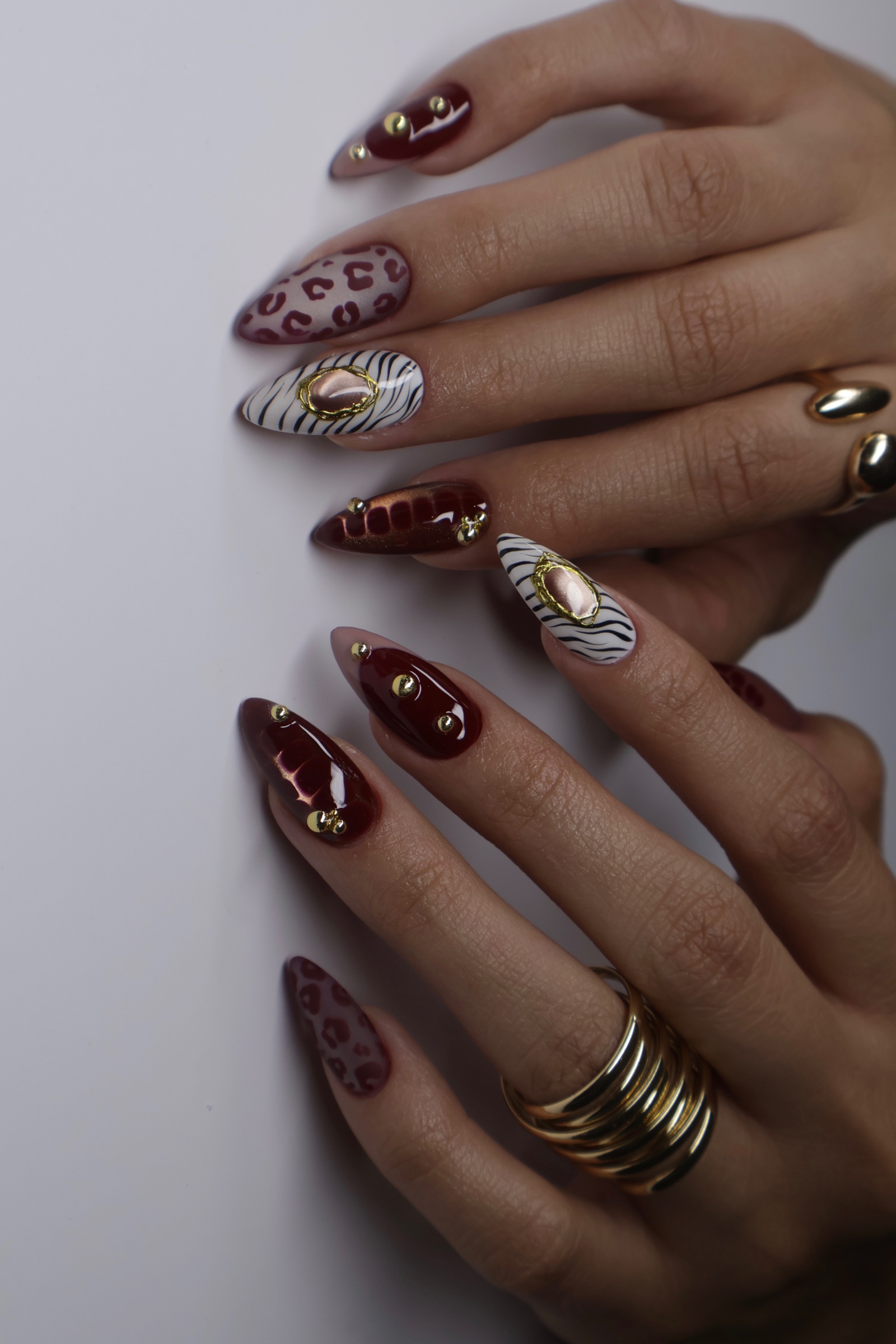 Extra-long stiletto nails, nude with white wave tips and gold leaf